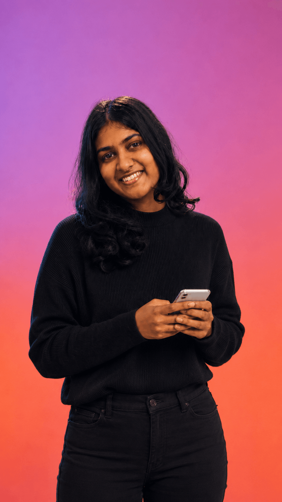 Woman smiling while using her phone