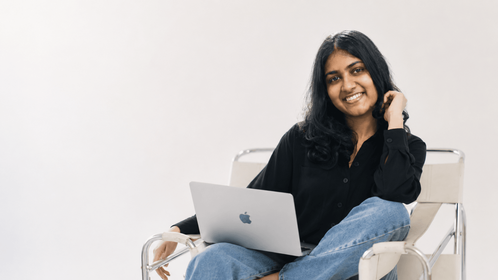 Upeksha Deshapriya smiling, seated with a laptop