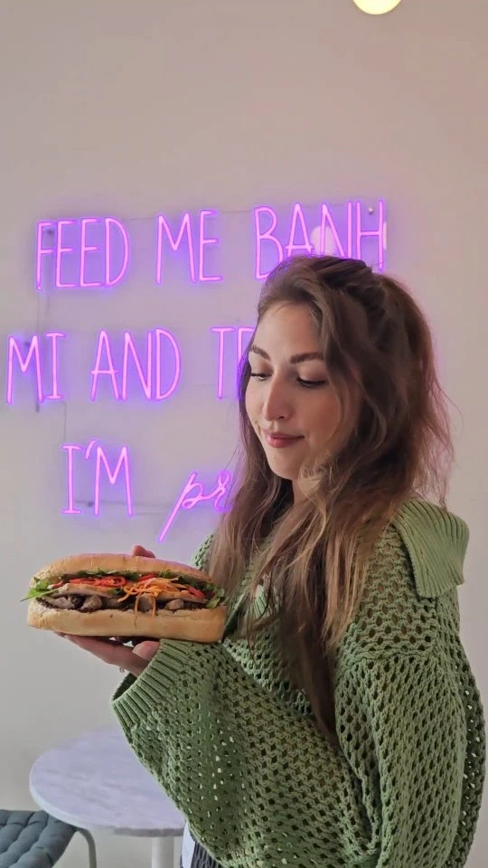 A guest holding a Bánh Mì
